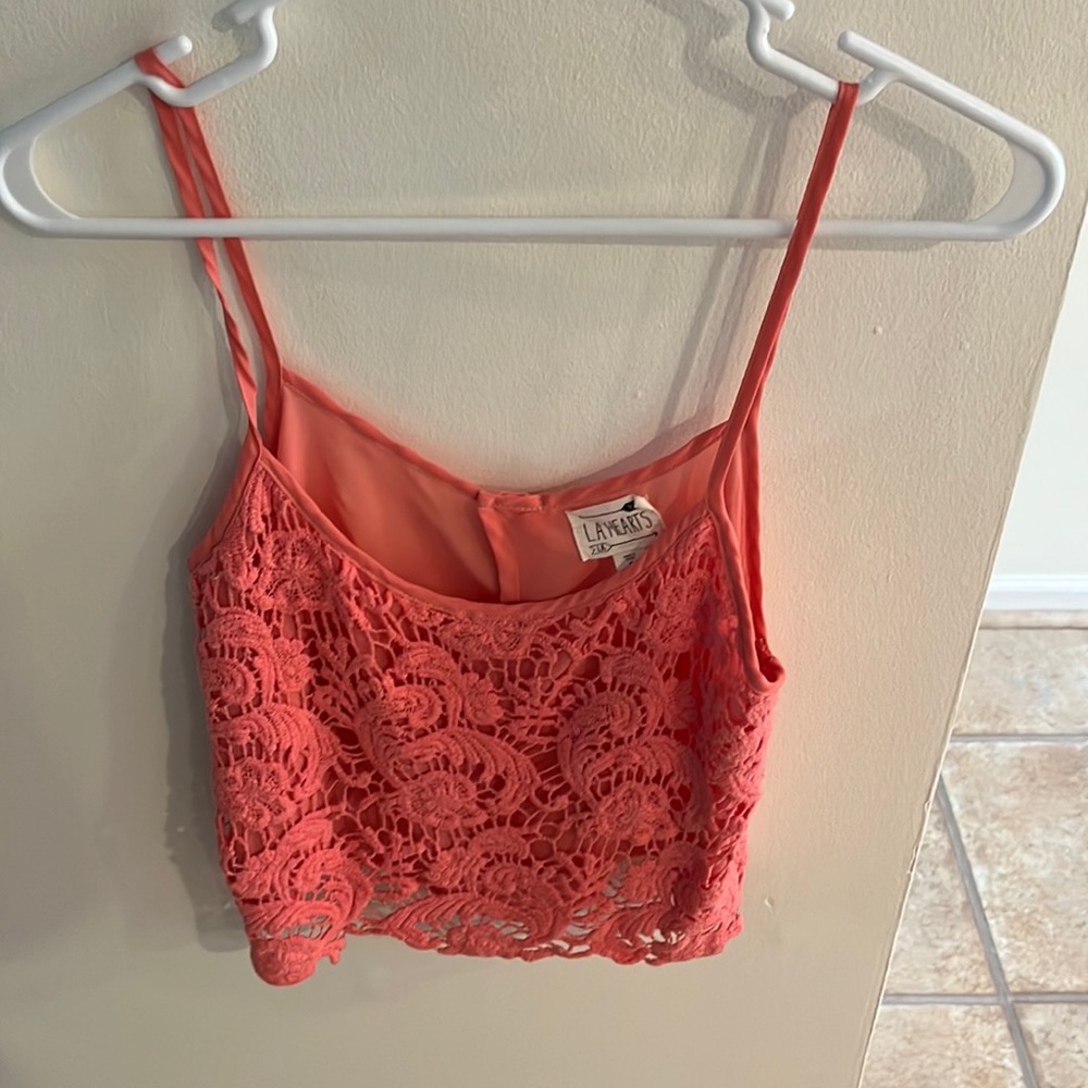 Super cute and flowy cropped tank top with flower designs on it. Worn once!